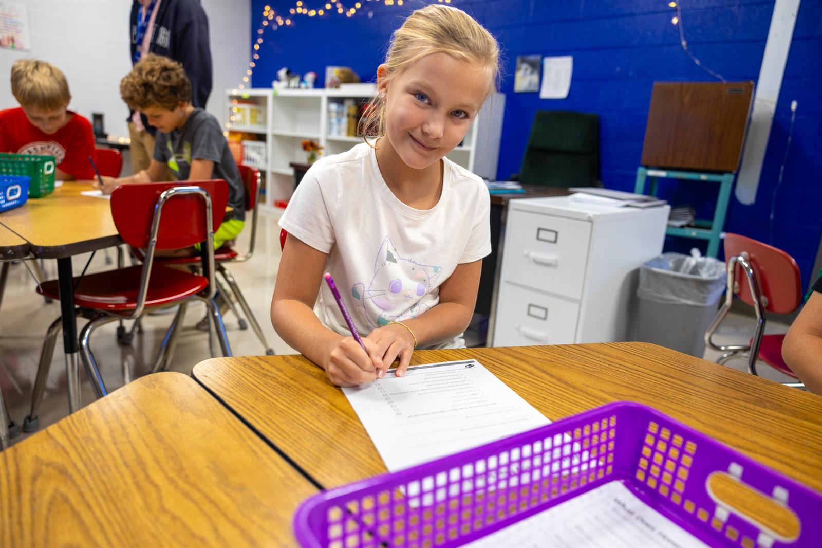 Student writing in a notebook